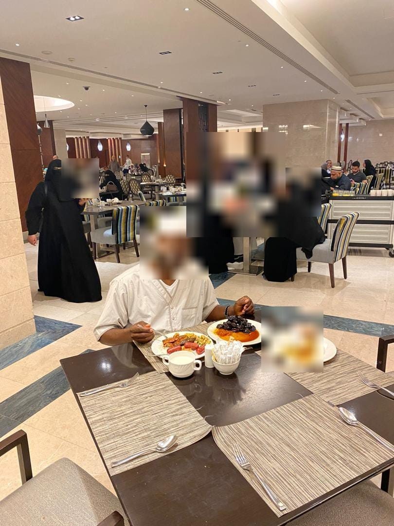 Al Mubarak pilgrims sharing a meal at their hotel in Saudi Arabia